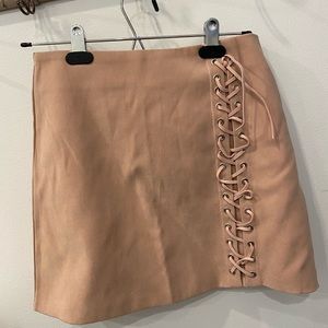 Pink suede skirt with detail along the side good for college